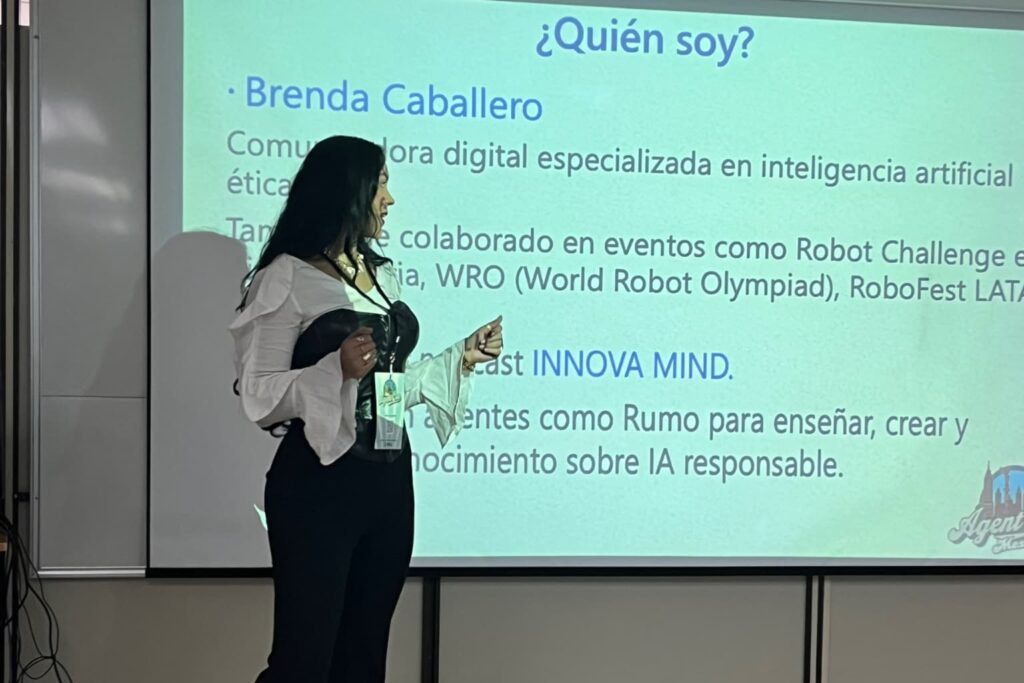 Fotografía de Brenda Caballero presentando una conferencia sobre inteligencia artificial ética, frente a una diapositiva con información de su trayectoria profesional.